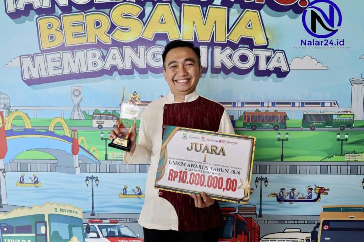 Pria tersenyum memegang trofi dan sertifikat penghargaan dari Pemkot Tangerang