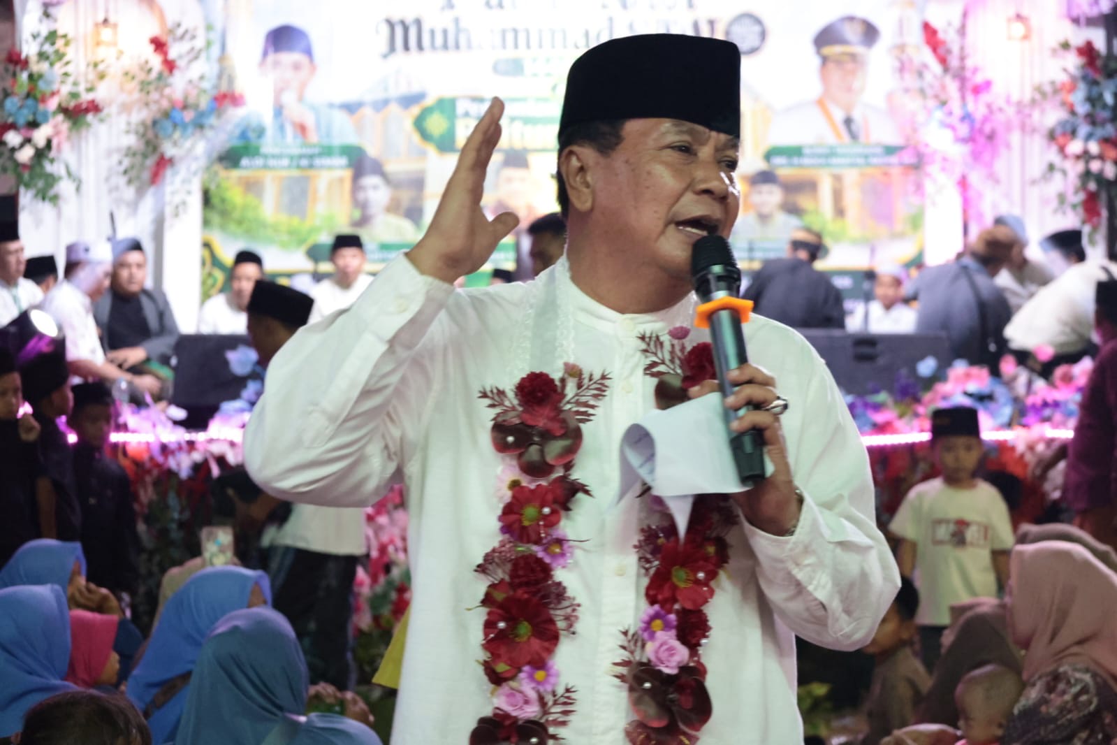 Bupati Tangerang Moch Maesyal Rasyid berpidato mengenakan baju putih dan kalungan bunga saat peresmian Masjid Jami Baiturrahman dirangkaikan Maulid Nabi di Sukamulya