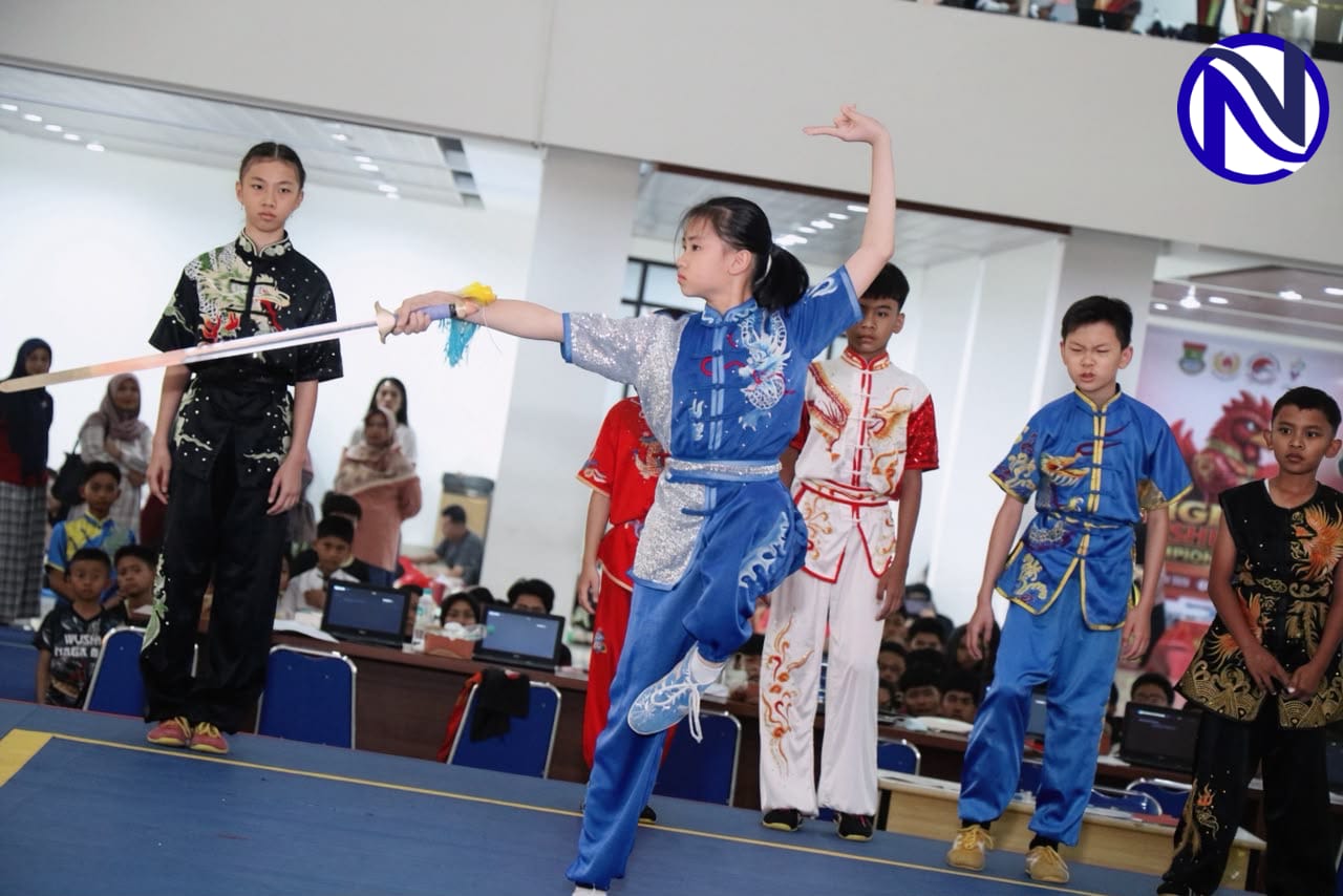 Atlet wushu cilik berbaju biru melakukan jurus pedang saat TWOC 2026 di Universitas Tangerang Raya